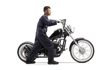 Fototapeta na wymiar Motorcycle mechanic pushing a chopper motorbike