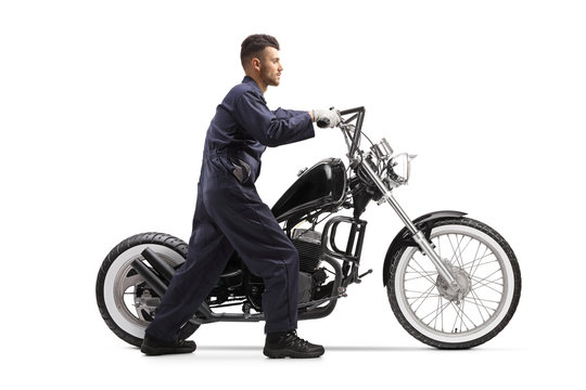 Motorcycle Mechanic Pushing A Chopper Motorbike