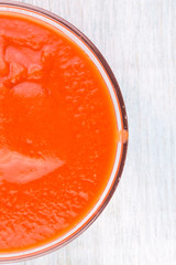 Tomato paste in a bowl close-up, top view