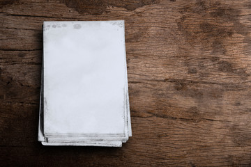 Old white paper on wooden floor background.