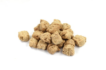 Raw dehydrated soy meat on white background. Pieces of dry soy meat. Textured Soy Protein.