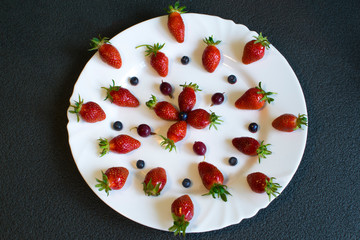 Sliced strawberries are decoratively placed on a white plate