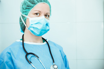 Doctora o enfermera con gorro y mascarillas en tiempos mostrándose feliz y orgullosa por su...