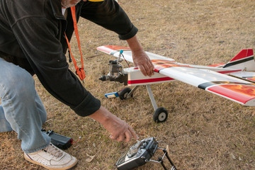 The man starts the engine on the aircraft model