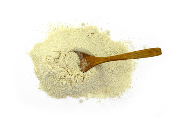 Pile of corn flour with a wooden spoon isolated on white background.