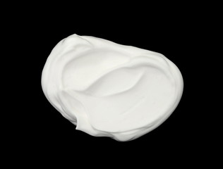 whipped cream or meringue isolated on black background. 