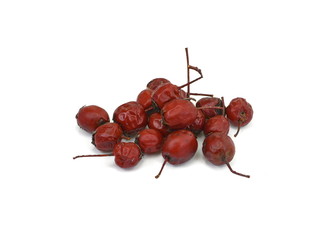 Dried medicinal herbs raw materials isolated on white. Fruit of Crataegus commonly called hawthorn, thornapple, May-tree, whitethorn, or hawberry. Cure for the heart.