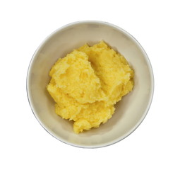 Polenta in a ceramic bowl isolated on white background.