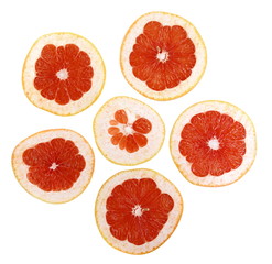 Slices of red grapefruit isolated on white background.
