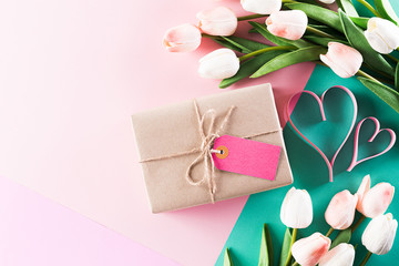Happy Mother's Day, Women's Day or Valentine's Day greeting concept. Pastel Colours Background with  tulip flowers and gift box ,flat lay patterns.