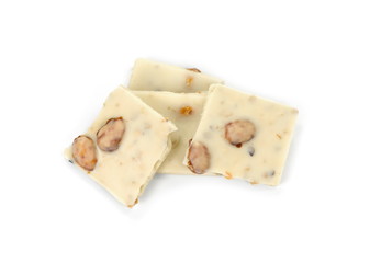 White chocolate pieces with pistachios and almonds isolated on white background.