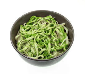 Italian Food. Pasta with original pesto green sauce in Genoa (Genova) Italy on white plate background, Pasta with basil pesto herbs background.