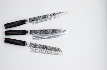 Japanese damascus kitchen knifes on the white backround