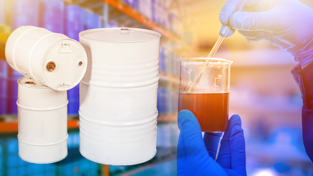 Metal barrels as a symbol of crude oil. Concept - oil analysis for composition. Diluted oil in vitro. Concept - petroleum analysis for classification. Chemical classification of petroleum products.