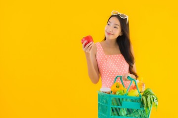 Portrait beautiful young asian woman with grocery in basket shopping from supermarket
