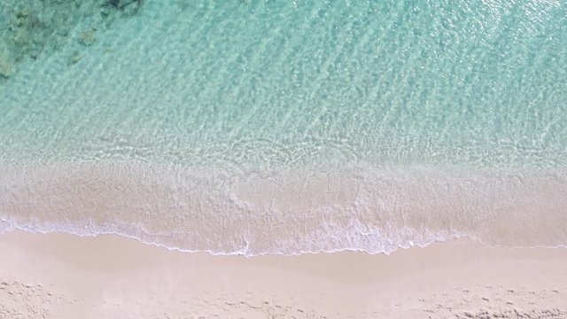 Aerial Drone Top-Down Zenithal still view of pink sand beach and turquoise water, Ibiza, Formentera, Spain