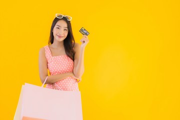 Portrait beautiful young asian woman with colorful shopping bag with smart mobile phone and credit card