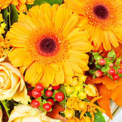Orange bouquet of flowers from gerberas, berries and roses. 