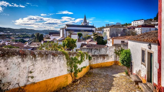 A scenic medieval townscape at the cobblestone footpaths of Obidos, Portugal