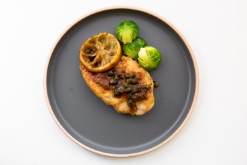 Italian food Lemon chicken Piccata  with Brussels Sprouts