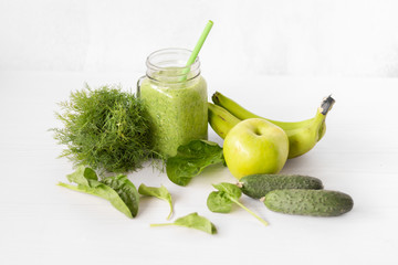 Mixed green smoothie with ingredients