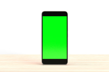 Mobile phone on wooden table surface isolated on white background. Smartphone with blank green screen chroma key. Telephone technology background.