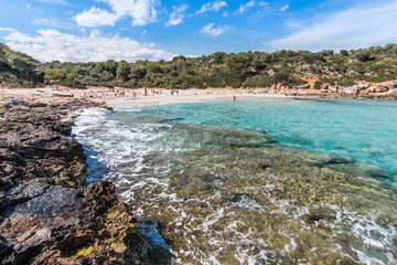 Landscape of sky, sea and people on the beach. Cala Sa Nau, Majorca