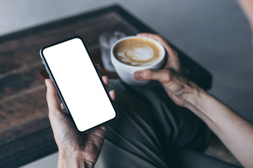 cell phone Mockup image blank white screen.woman hand holding texting using mobile on desk at coffee shop.background empty space for advertise.work people contact marketing business,technology