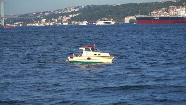 ISTANBUL - JUNE 2, 2018 : Small white boat is sailing along the Bosphorus. 4k.