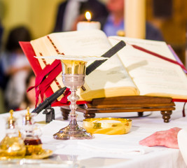 altar with missal and host which becomes the body of Christ and chalice to receive the wine, the...