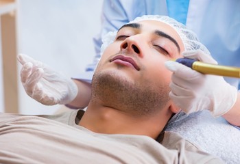 Obraz na płótnie Canvas Man visiting dermatologyst for laser scar removal