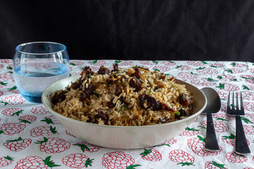 A plate of fried rice with beef and mushroom served on a table in a restaurant