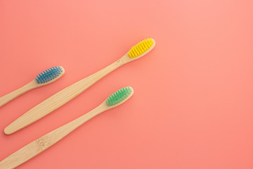 wooden toothbrush on pink background