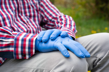 Disabled enderly man's hands with gloves