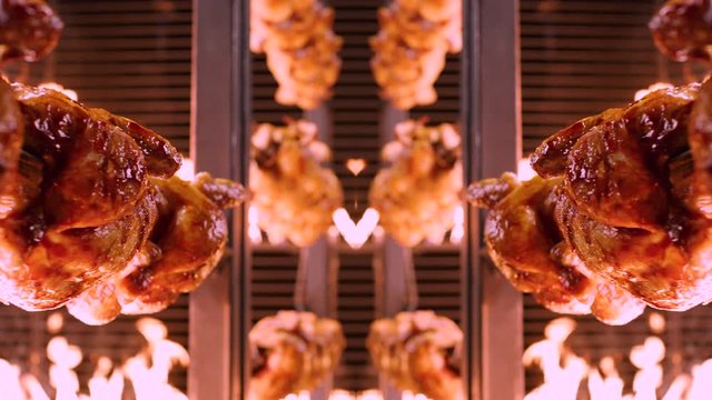 Symmetrically aligned chickens on spikes rotating in rotisserie between walls of flames