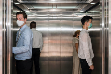 new normal practise keep social distancing in elevator at office