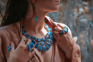 close up of woman hands with with gem stones accessories outdoors