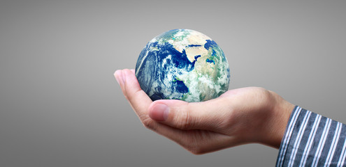 Globe ,earth in  hand, holding our planet glowing. Earth image provided by Nasa