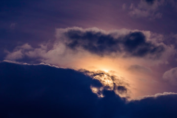 Moonrise behind clouds