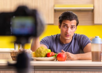 Fototapeta premium Young man blogging about food supplements