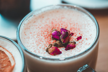 cappuccino decorated with flowers and oranges