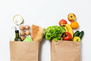 Food delivery. Paper bag with vegetables and fruits on a white background. Online order from the grocery store