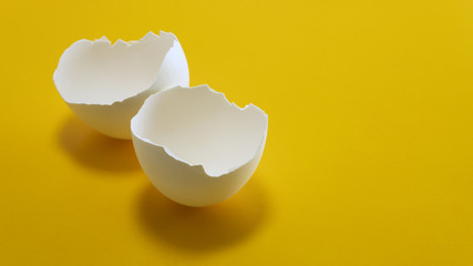 broken eggshell on a yellow background
