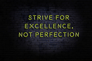 Smart and motivational quotation. Neon sign on brick wall