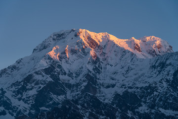Fototapeta na wymiar Red morning sunrise light over Annapurna south mountain peak view from Mardi Himal trekking route, Himalaya mountains range in Nepal
