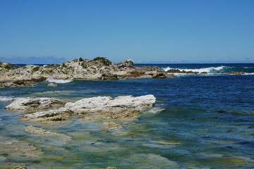 Fototapeta na wymiar Blue water around the rocks