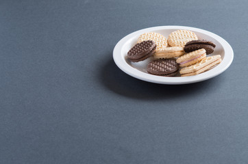 Assorted cream cookies and biscuits sitting on a plate