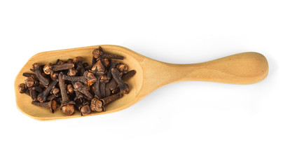 dried cloves in the wooden spoon, isolated on white background