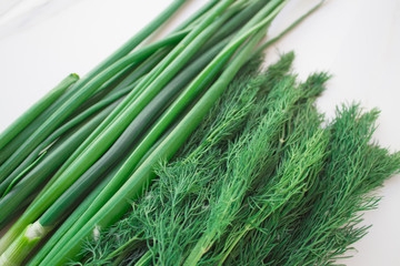  Fresh dill and green onions with vegetable garden close-up, top view.Greens for vitamin smoothie,healthy eating concept