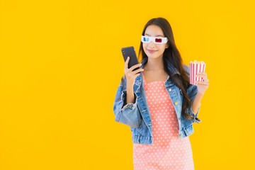 Portrait beautiful young asian woman enjoy happy with phone popcorn and watch movie
